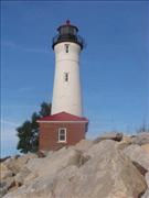 Rocky shore and lighthouse, Michigan